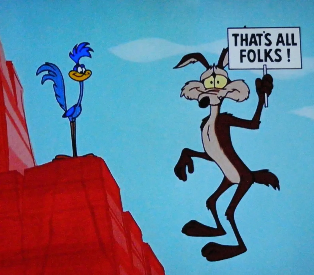 In a classic cartoon scene, the Road Runner stands triumphantly on a hill as Wile E. Coyote plummets below, holding a "That's All Folks!" sign.